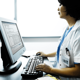 QA Portal - Image of a physician working on a computer