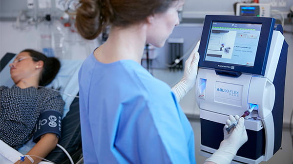 Nurse performing a blood gas analysis on the ABL90 FLEX plus from Radiometer